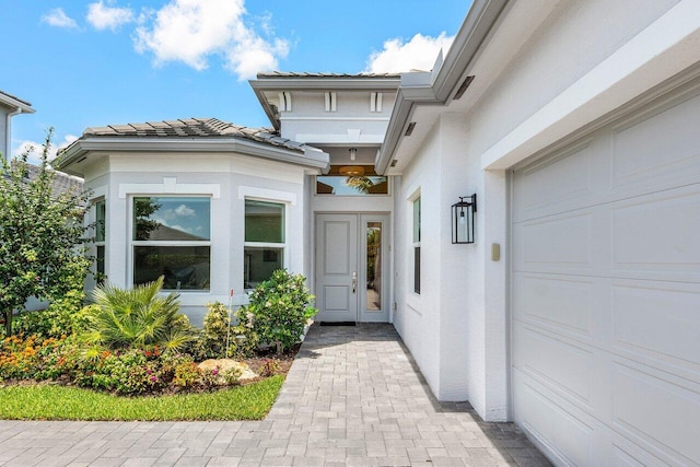 13487 Whistler Mountain Rd, Delray Beach, FL 33446 - view of exterior entry with stucco siding and a tiled roof
