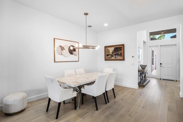 13487 Whistler Mountain Rd, Delray Beach, FL 33446 - dining space with light wood-type flooring, a chandelier, baseboards, and recessed lighting