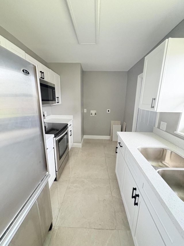 324W W 5th Ter, Pahokee, FL 33476 - kitchen featuring stainless steel appliances, white cabinetry, baseboards, and a sink