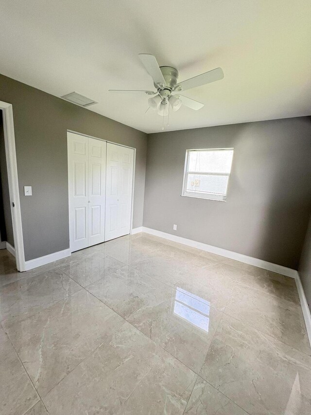 324W W 5th Ter, Pahokee, FL 33476 - unfurnished bedroom with baseboards, a closet, and ceiling fan