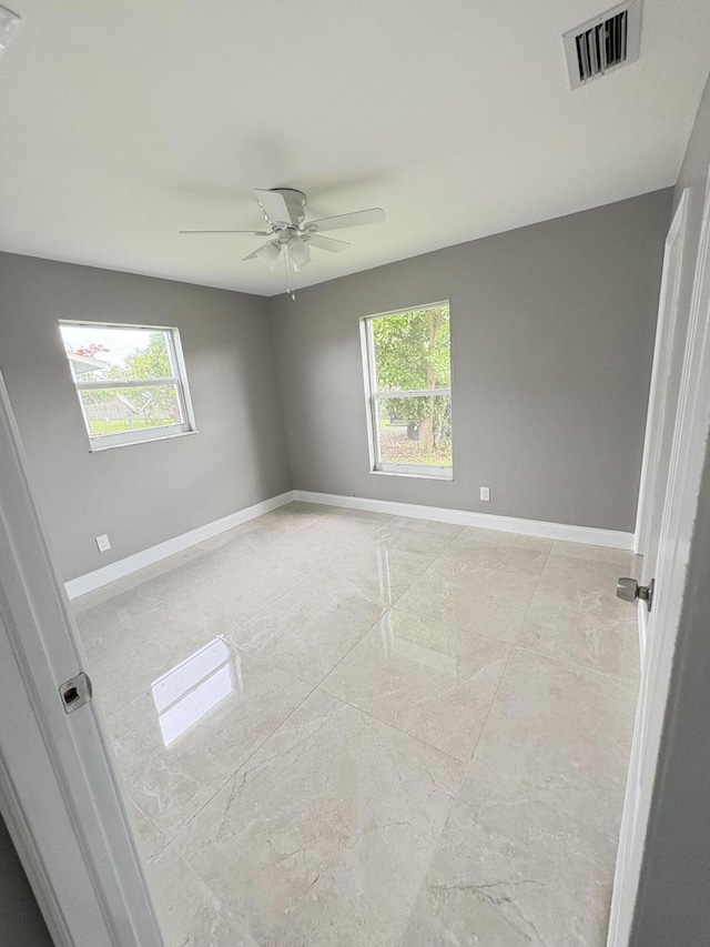 324W W 5th Ter, Pahokee, FL 33476 - spare room with healthy amount of natural light, a ceiling fan, and baseboards