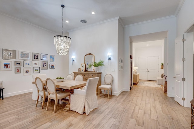 314 Sonoma Isles Cir, Jupiter, FL 33478 - dining area with light wood-style floors, a chandelier, recessed lighting, crown molding, and baseboards
