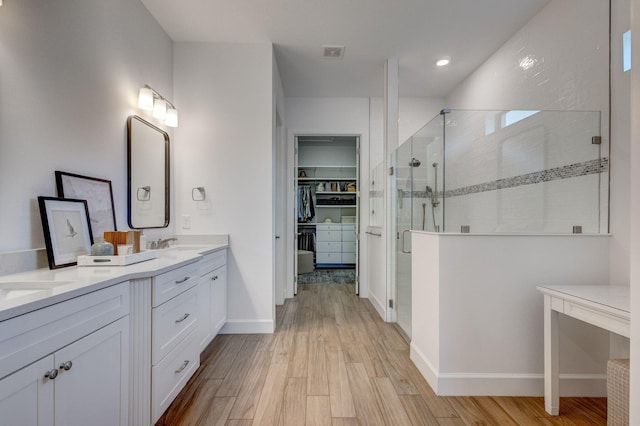 314 Sonoma Isles Cir, Jupiter, FL 33478 - full bathroom featuring a shower stall, a spacious closet, double vanity, wood finished floors, and recessed lighting