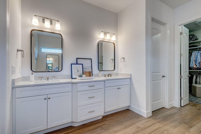 314 Sonoma Isles Cir, Jupiter, FL 33478 - bathroom featuring double vanity, wood finished floors, a spacious closet, and baseboards
