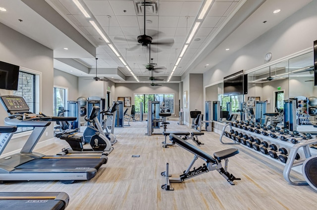 314 Sonoma Isles Cir, Jupiter, FL 33478 - exercise room with ceiling fan, baseboards, wood finished floors, a high ceiling, and healthy amount of natural light