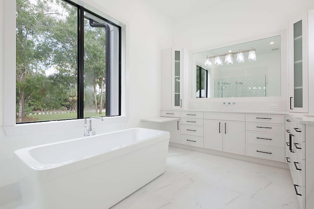 18072 127th Dr N, Jupiter, FL 33478 - bathroom with vanity, a stall shower, a freestanding tub, and marble finish flooring
