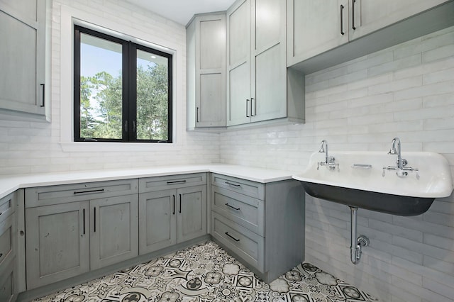 18072 127th Dr N, Jupiter, FL 33478 - kitchen with gray cabinetry, decorative backsplash, light countertops, and light tile patterned floors