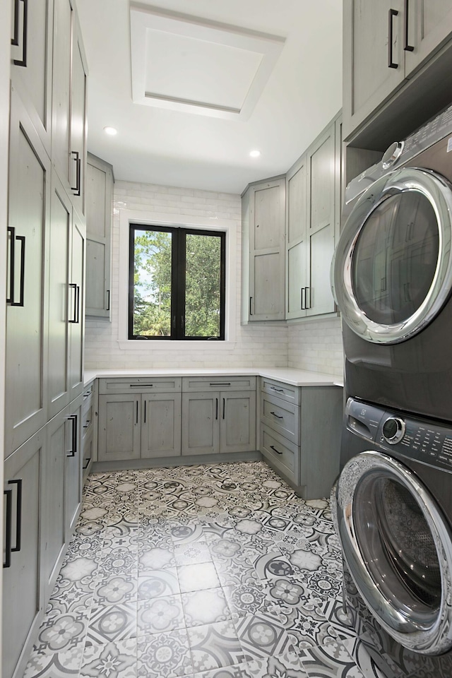 18072 127th Dr N, Jupiter, FL 33478 - washroom featuring stacked washer / dryer, cabinet space, and recessed lighting