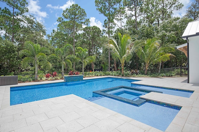 18072 127th Dr N, Jupiter, FL 33478 - view of swimming pool with a patio, a pool with connected hot tub, and view of wooded area