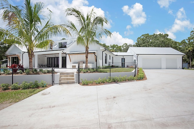 18072 127th Dr N, Jupiter, FL 33478 - view of front of home featuring a fenced front yard, driveway, a gate, and a garage