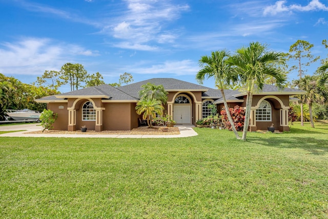 12098 86th Rd N, The Acreage, FL 33412 - view of front of home featuring stucco siding and a front yard