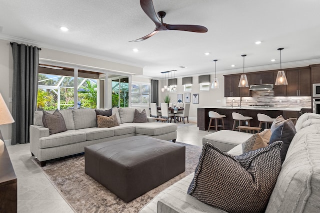 10339 SW Tetian Dr, Port Saint Lucie, FL 34987 - living area featuring recessed lighting, a ceiling fan, crown molding, and a chandelier