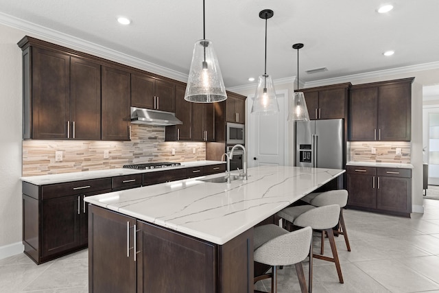 10339 SW Tetian Dr, Port Saint Lucie, FL 34987 - kitchen featuring a sink, stainless steel appliances, under cabinet range hood, decorative backsplash, and a breakfast bar