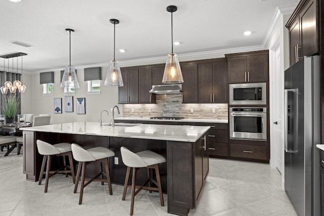 10339 SW Tetian Dr, Port Saint Lucie, FL 34987 - kitchen with appliances with stainless steel finishes, backsplash, ornamental molding, a sink, and a center island with sink