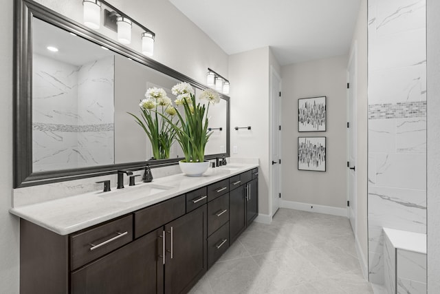 10339 SW Tetian Dr, Port Saint Lucie, FL 34987 - bathroom with double vanity, baseboards, and marble look tile flooring