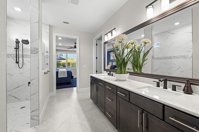10339 SW Tetian Dr, Port Saint Lucie, FL 34987 - full bathroom with connected bathroom, double vanity, a marble finish shower, marble look tiles, and ceiling fan