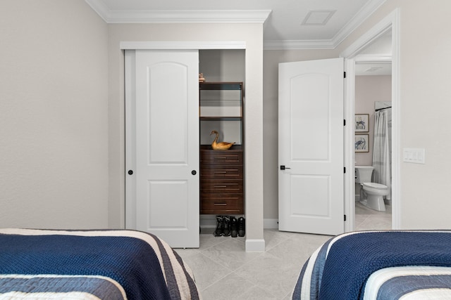 10339 SW Tetian Dr, Port Saint Lucie, FL 34987 - bedroom featuring ornamental molding, a closet, light tile patterned floors, connected bathroom, and baseboards