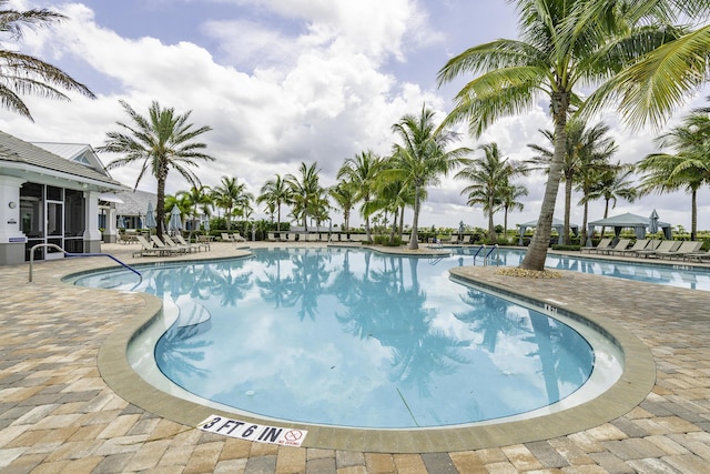 10339 SW Tetian Dr, Port Saint Lucie, FL 34987 - community pool with a patio and a sunroom