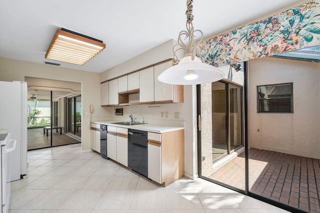 16703 Hidden Cove Dr, Jupiter, FL 33477 - kitchen with dishwasher, a sink, light countertops, freestanding refrigerator, and white cabinets