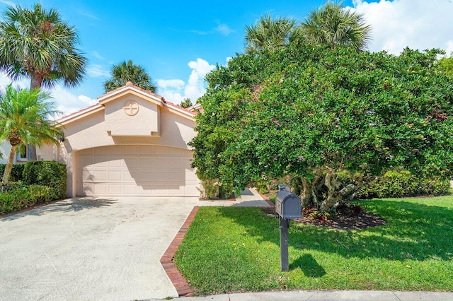 16703 Hidden Cove Dr, Jupiter, FL 33477 - view of front of house featuring stucco siding, a front yard, a garage, and driveway
