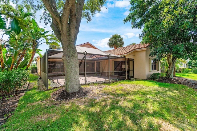 16703 Hidden Cove Dr, Jupiter, FL 33477 - view of green lawn with a patio area and glass enclosure