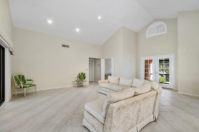 16703 Hidden Cove Dr, Jupiter, FL 33477 - living room with high vaulted ceiling, french doors, baseboards, and light tile patterned floors