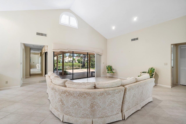 16703 Hidden Cove Dr, Jupiter, FL 33477 - living area with high vaulted ceiling, baseboards, and light tile patterned floors