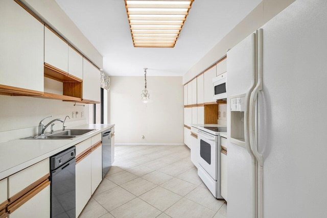 16703 Hidden Cove Dr, Jupiter, FL 33477 - kitchen featuring white appliances, a sink, white cabinetry, light countertops, and light tile patterned floors