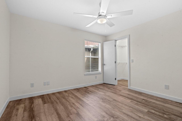 1825 Palm Cove Blvd Unit 7-307, Delray Beach, FL 33445 - unfurnished bedroom featuring wood finished floors, baseboards, a spacious closet, and ceiling fan