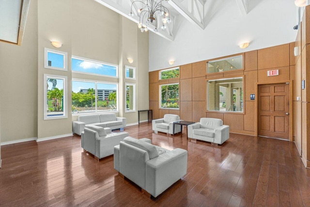 1825 Palm Cove Blvd Unit 7-307, Delray Beach, FL 33445 - living room with a towering ceiling, dark wood-type flooring, baseboards, and a chandelier