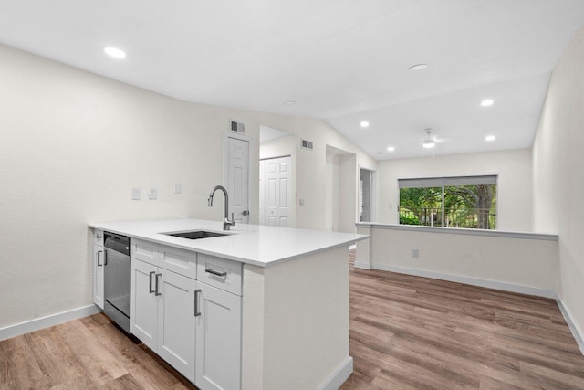 1825 Palm Cove Blvd Unit 7-307, Delray Beach, FL 33445 - kitchen featuring a sink, stainless steel dishwasher, a peninsula, lofted ceiling, and white cabinets