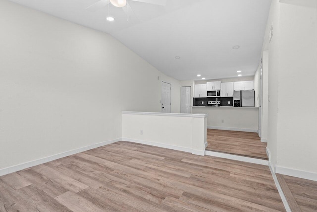 1825 Palm Cove Blvd Unit 7-307, Delray Beach, FL 33445 - unfurnished living room with a ceiling fan, light wood-style flooring, recessed lighting, baseboards, and lofted ceiling