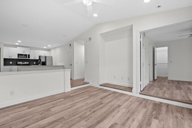 1825 Palm Cove Blvd Unit 7-307, Delray Beach, FL 33445 - unfurnished living room featuring a ceiling fan, light wood finished floors, recessed lighting, baseboards, and lofted ceiling