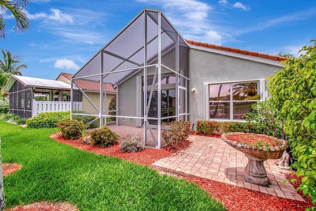 5630 Eagle Trace Ct, Lake Worth, FL 33463 - back of house with a patio area, stucco siding, a lawn, a lanai, and a tiled roof