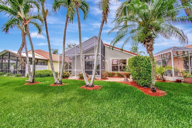 5630 Eagle Trace Ct, Lake Worth, FL 33463 - back of property with stucco siding, glass enclosure, and a yard