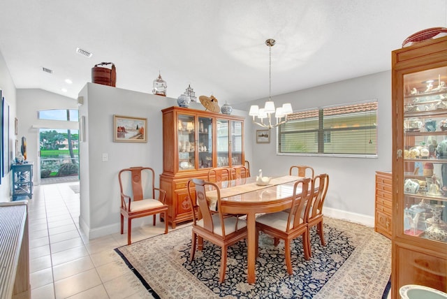 5630 Eagle Trace Ct, Lake Worth, FL 33463 - dining area featuring a chandelier, vaulted ceiling, light tile patterned flooring, and baseboards