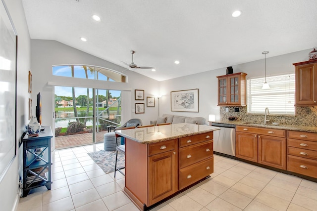 5630 Eagle Trace Ct, Lake Worth, FL 33463 - kitchen featuring dishwasher, a sink, vaulted ceiling, a ceiling fan, and brown cabinets