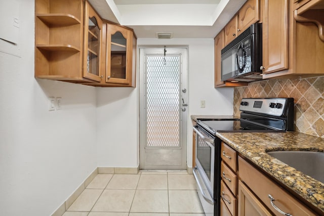 4500 N Federal Hwy Unit 367H, Lighthouse Point, FL 33064 - kitchen with electric range, black microwave, light tile patterned floors, backsplash, and dark stone countertops