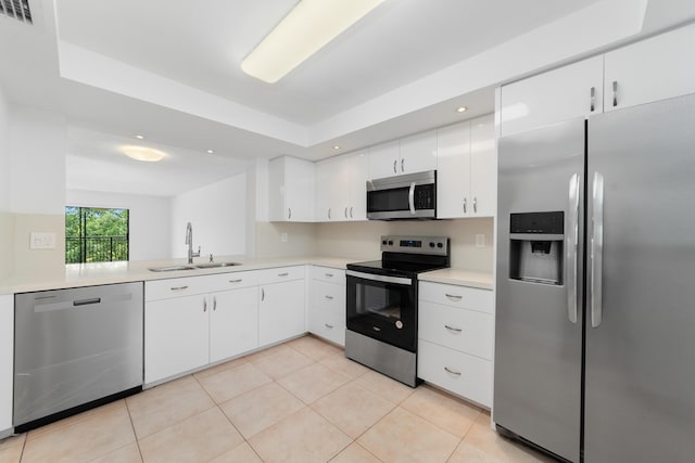16091 Blatt Blvd Unit 302, Weston, FL 33326 - kitchen with stainless steel appliances, a sink, light countertops, light tile patterned floors, and white cabinetry