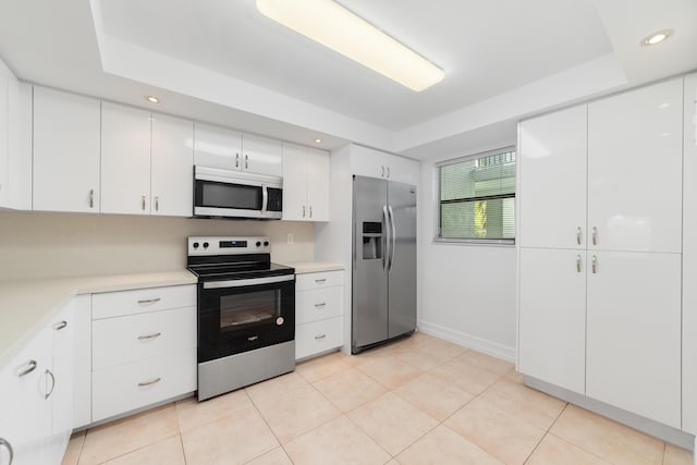 16091 Blatt Blvd Unit 302, Weston, FL 33326 - kitchen with stainless steel appliances, light countertops, white cabinetry, and recessed lighting