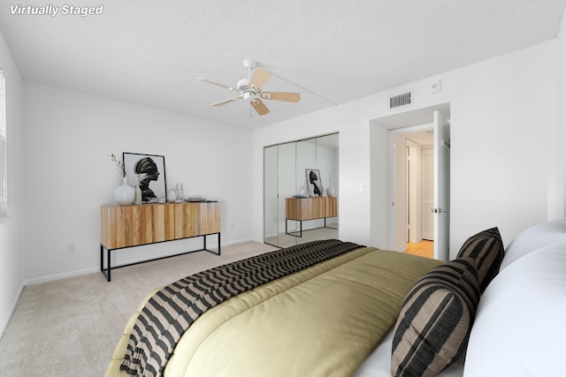 16091 Blatt Blvd Unit 302, Weston, FL 33326 - bedroom featuring light colored carpet, a closet, a ceiling fan, a textured ceiling, and baseboards