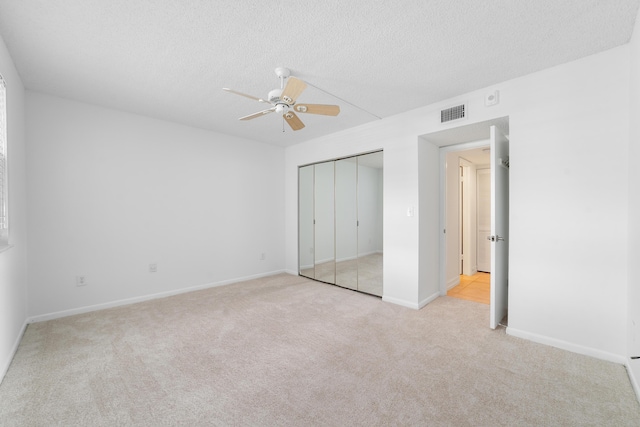16091 Blatt Blvd Unit 302, Weston, FL 33326 - unfurnished bedroom featuring carpet flooring, a textured ceiling, a closet, a ceiling fan, and baseboards