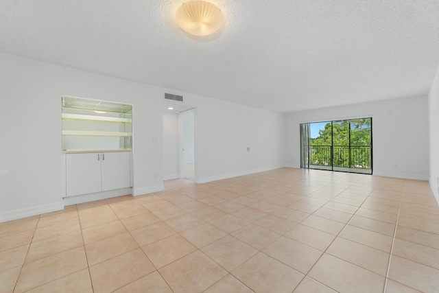 16091 Blatt Blvd Unit 302, Weston, FL 33326 - unfurnished room featuring light tile patterned floors, a textured ceiling, and baseboards