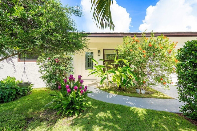 1701 N Ocean Breeze, Lake Worth Beach, FL 33460 - view of front facade with stucco siding and a front yard