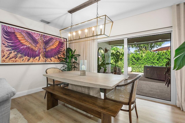 1701 N Ocean Breeze, Lake Worth Beach, FL 33460 - dining room featuring a chandelier and light wood-type flooring