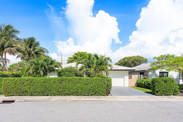 1701 N Ocean Breeze, Lake Worth Beach, FL 33460 - view of front of property with a garage, concrete driveway, and stucco siding