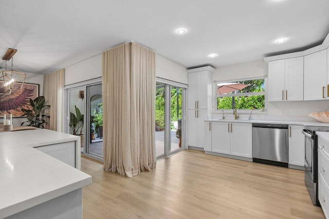 1701 N Ocean Breeze, Lake Worth Beach, FL 33460 - kitchen with dishwasher, range with electric stovetop, light countertops, light wood-style floors, and recessed lighting