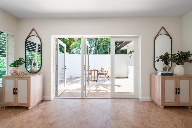 330 SE 7th Ave, Delray Beach, FL 33483 - doorway with french doors, light tile patterned flooring, and baseboards