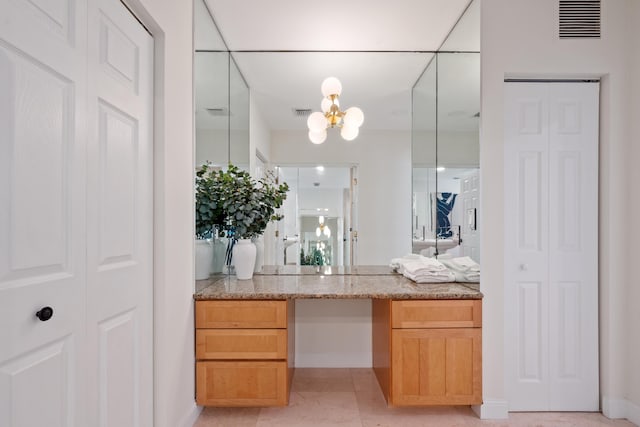 330 SE 7th Ave, Delray Beach, FL 33483 - bathroom with a closet, a chandelier, vanity, and baseboards
