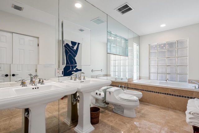 330 SE 7th Ave, Delray Beach, FL 33483 - bathroom featuring tiled bath, a bidet, toilet, a sink, and recessed lighting